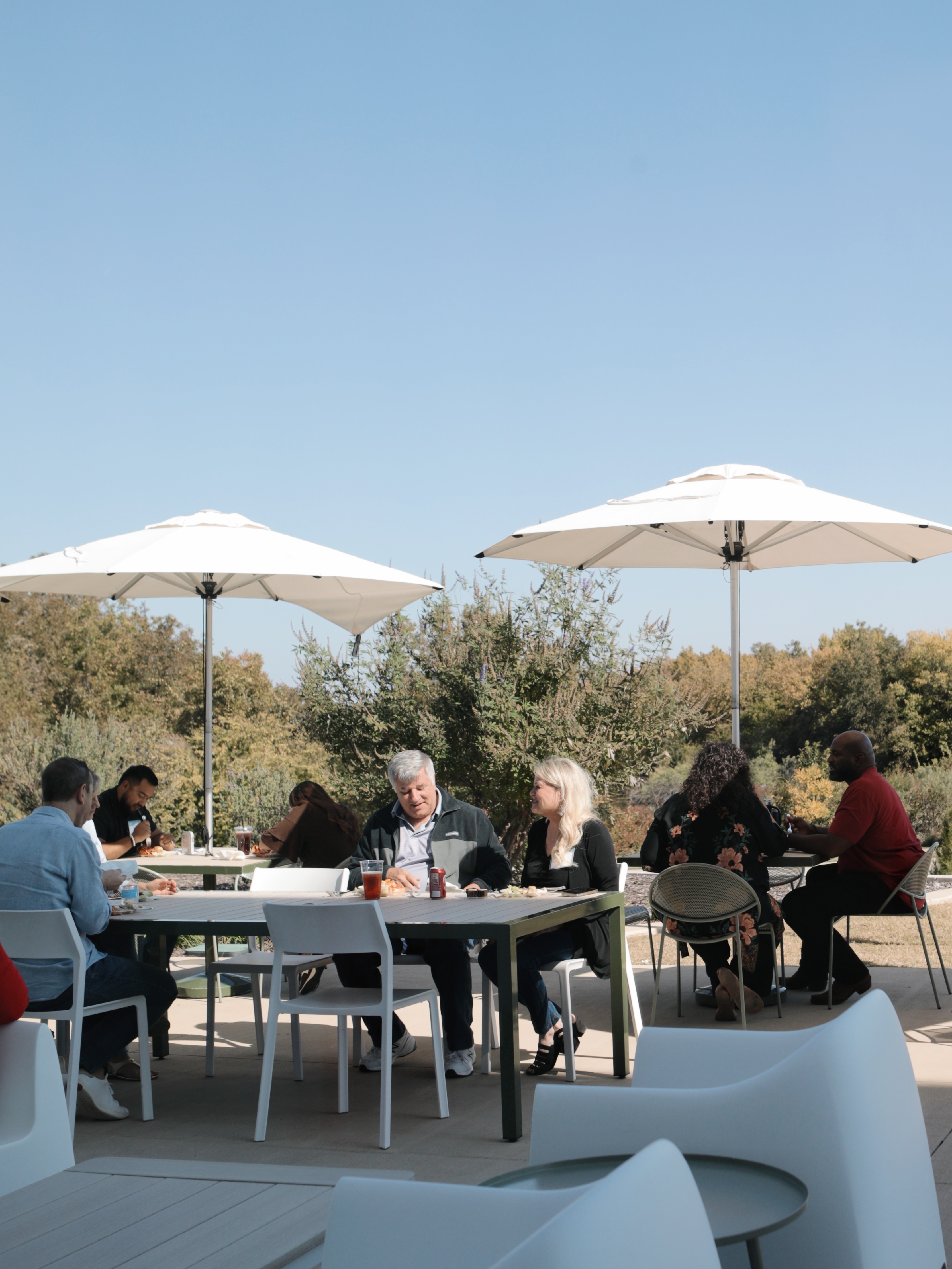 Couple sits at a picnic table talking during an XO Vision Retreat