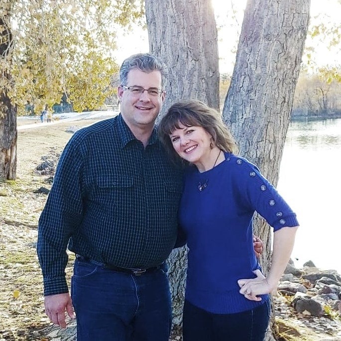 couple posing by a tree