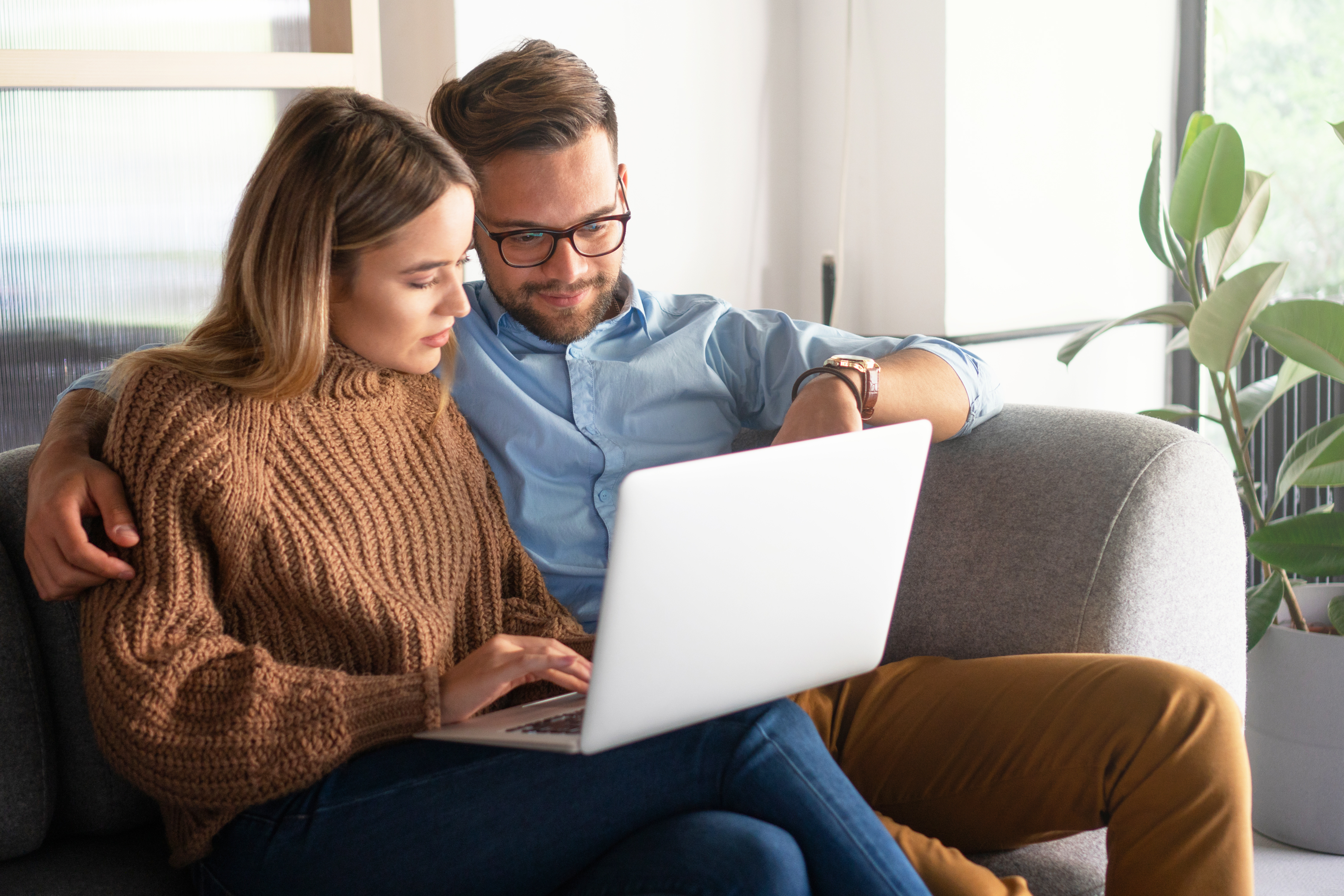 Christian couple sitting at laptop computer completing the XO Marriage Intensive intake form.