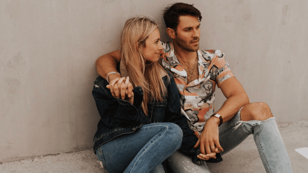 couple holding hands sitting