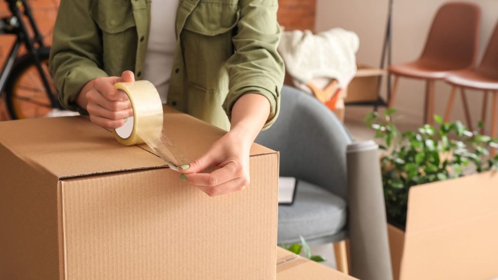 person taping box