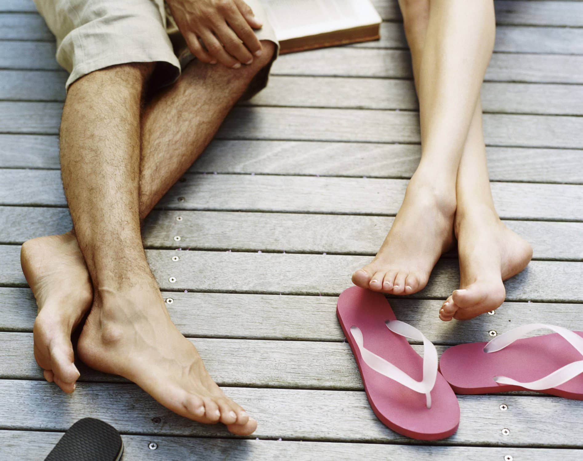 couple laying down on boardwalk