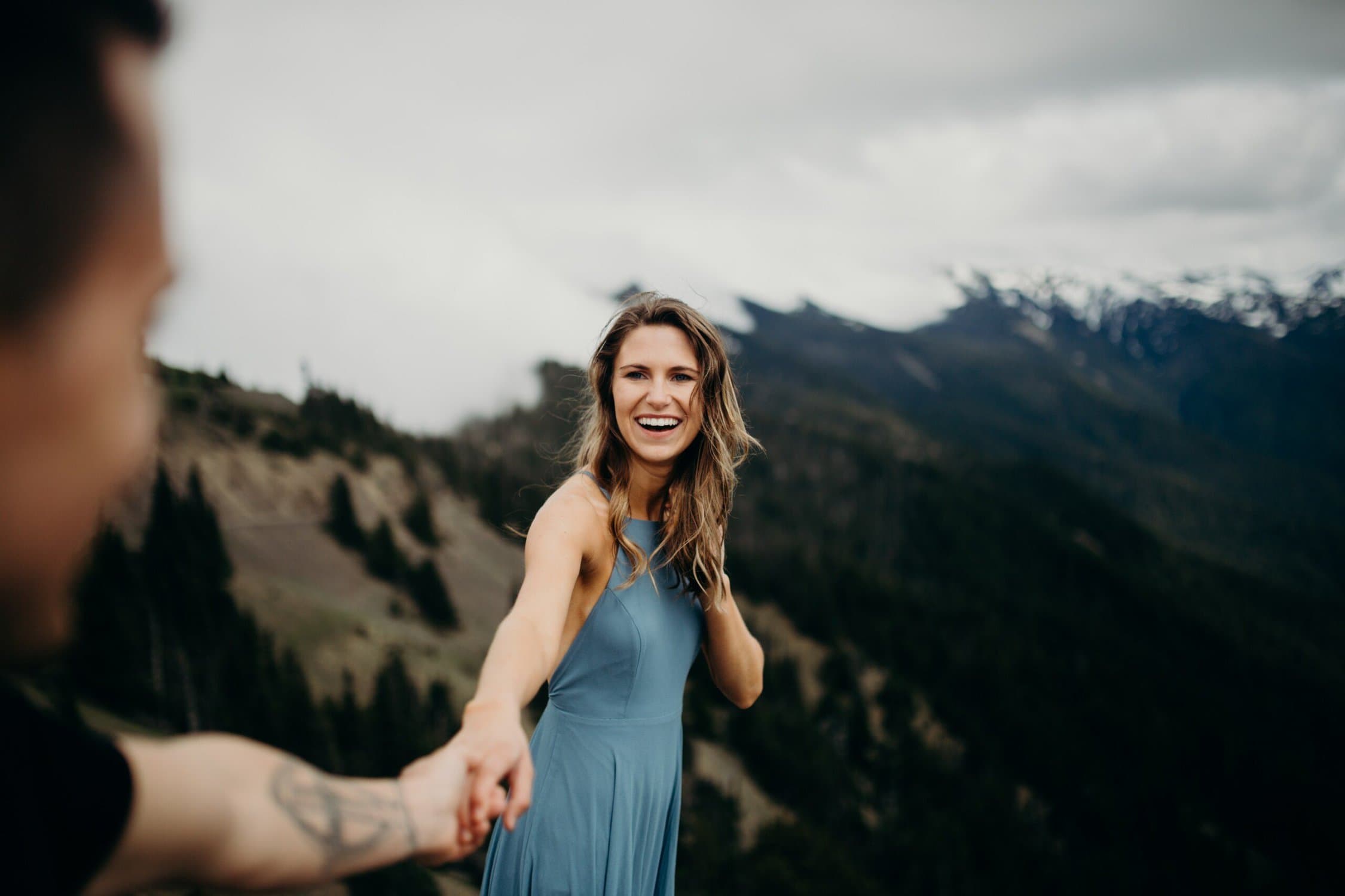 woman holding a hand with someone off camera