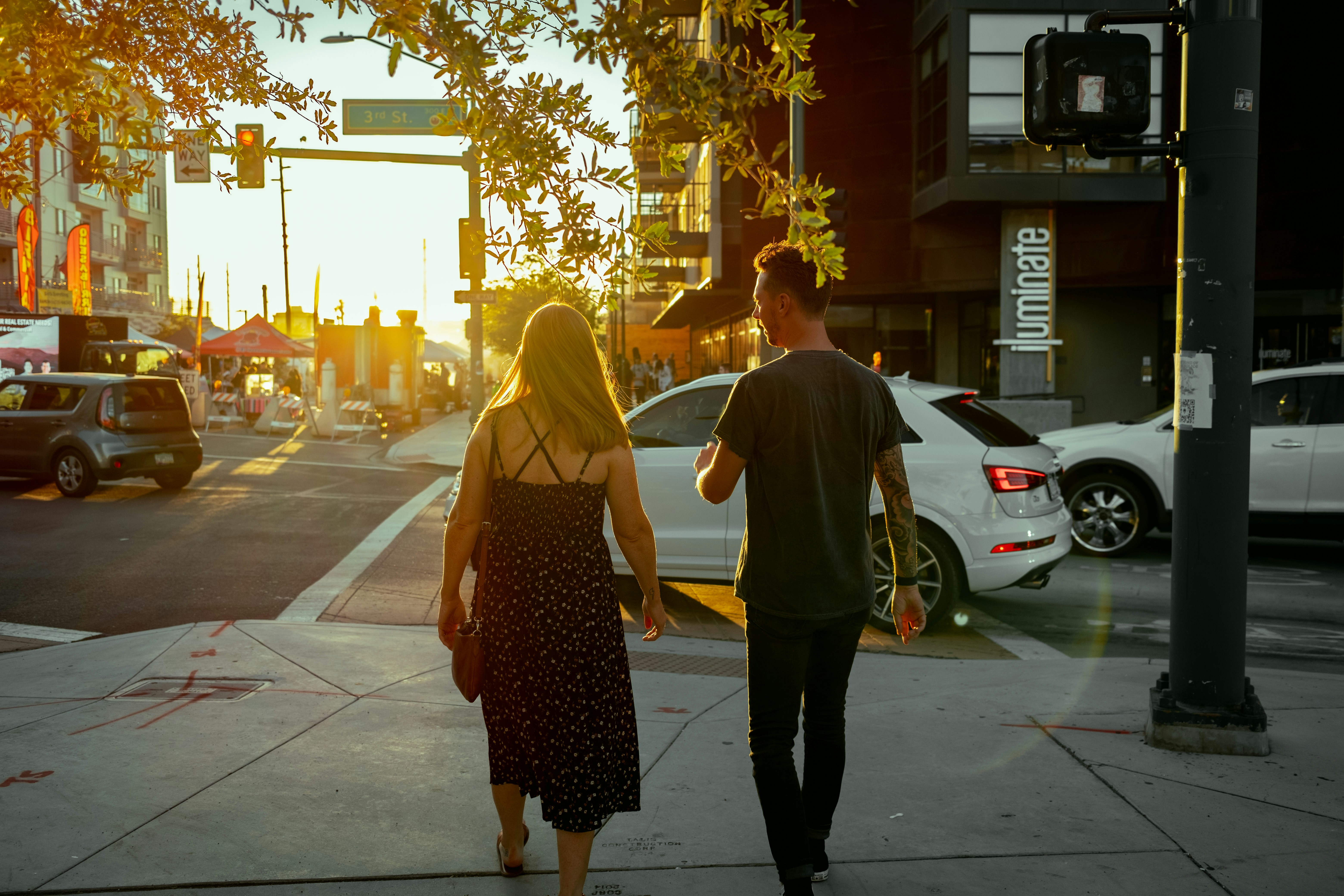 A husband and wife walking together down a sunny city sidewalk during a date night, symbolizing the importance of daily intention, pursuit, and quality time in a healthy Christian marriage.