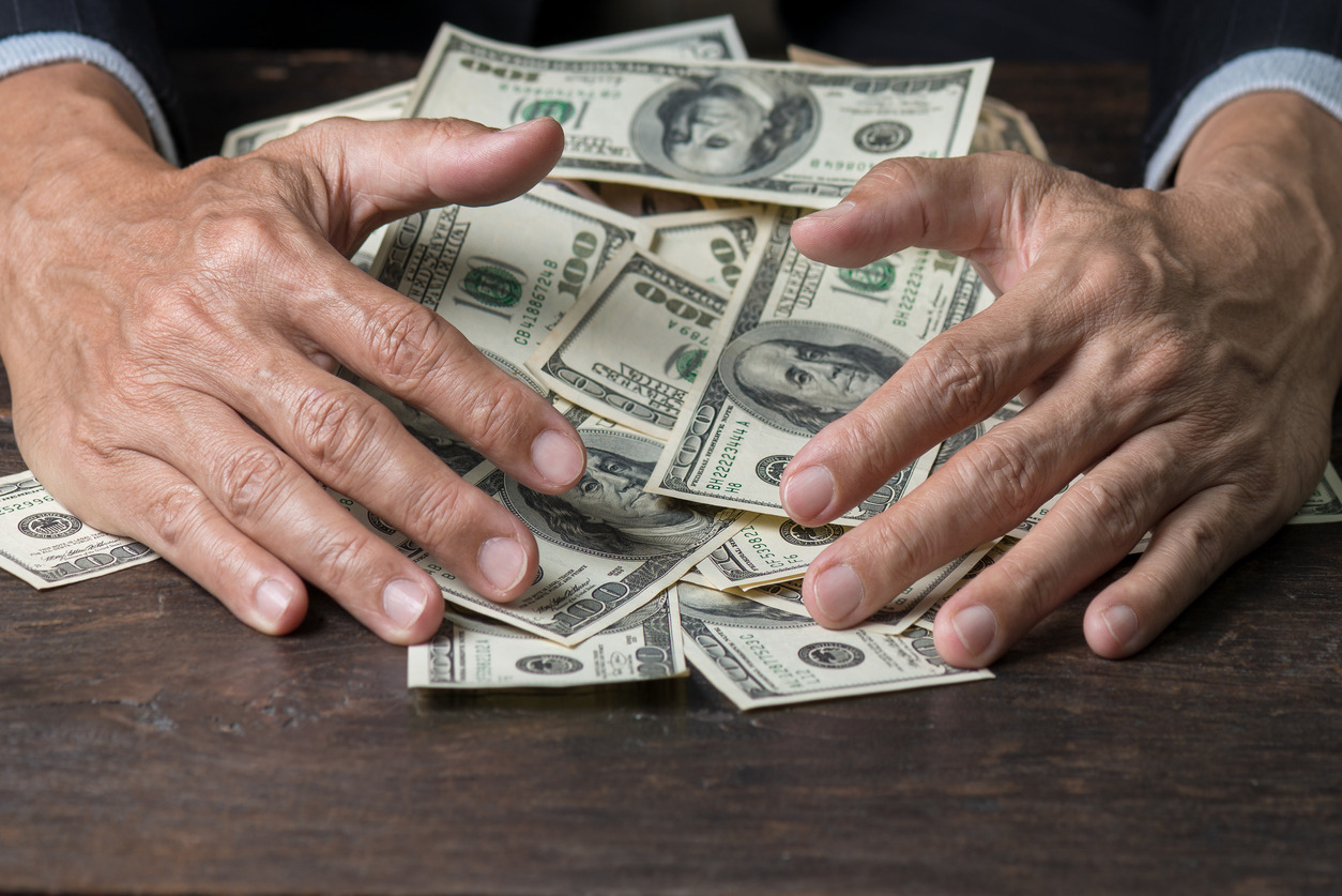 person holding a pile of money