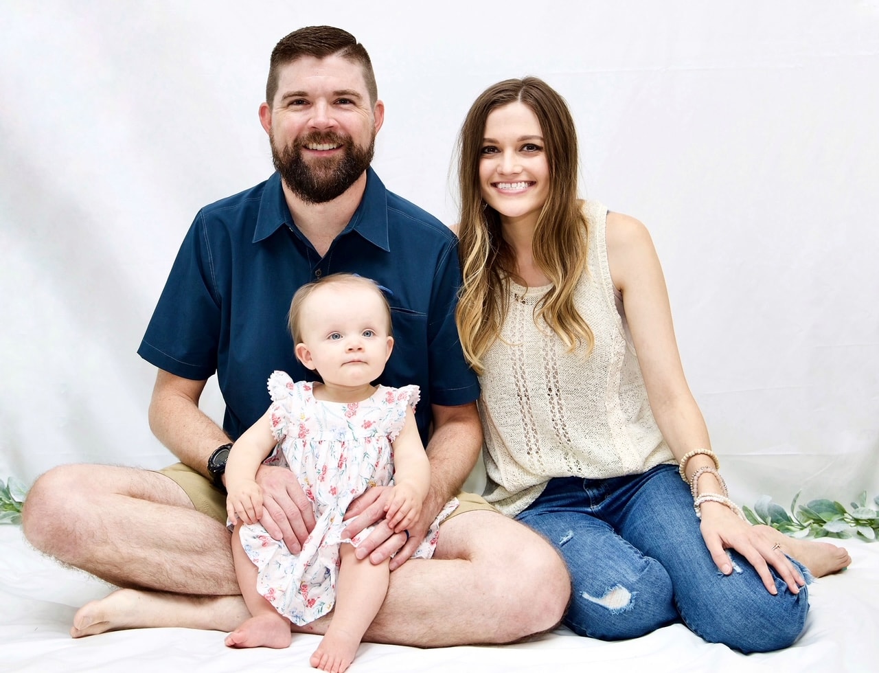 couple sitting with a baby