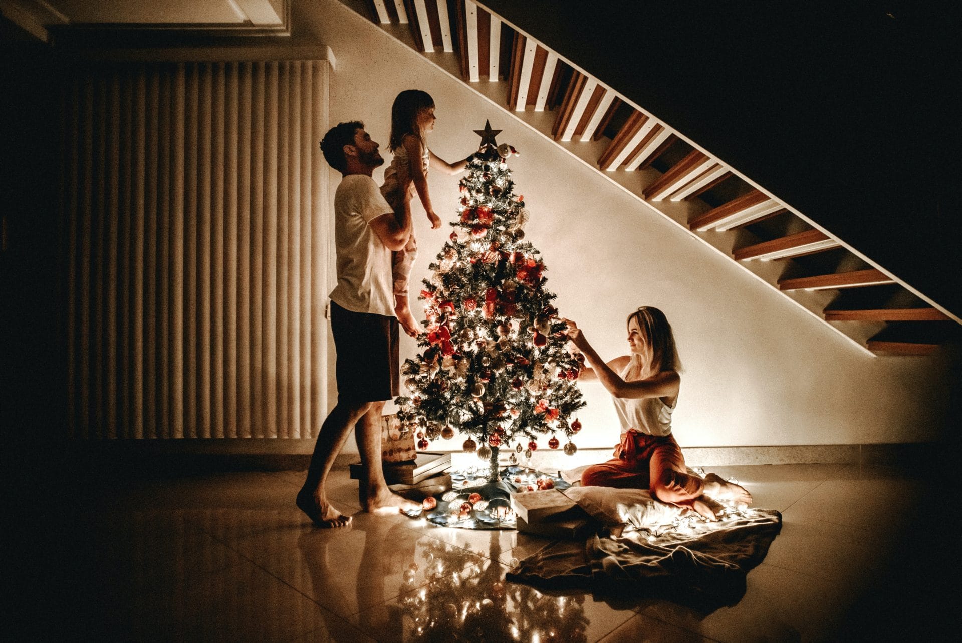 father with two kids at a christmas tree