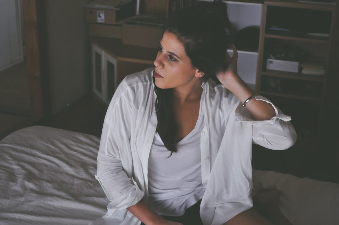 woman sitting on bed