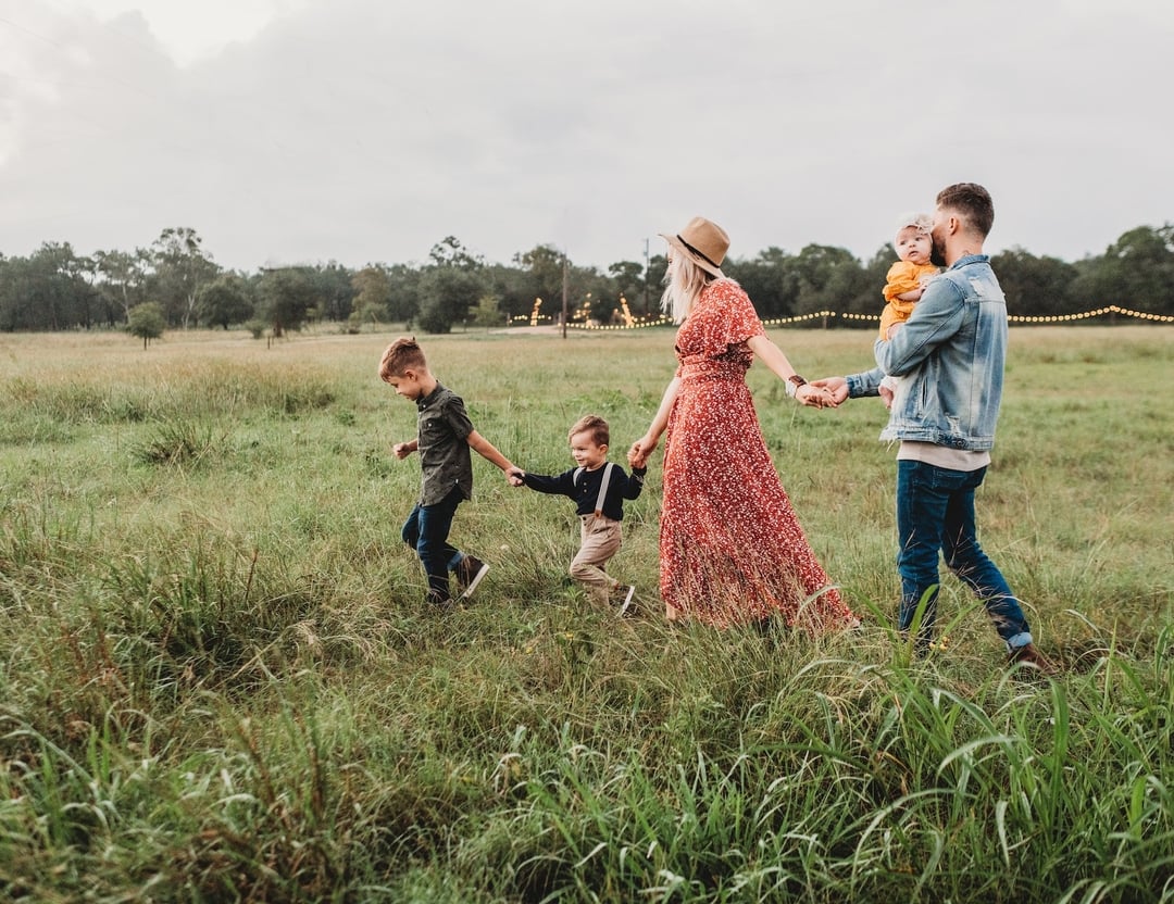 family on a field walking
