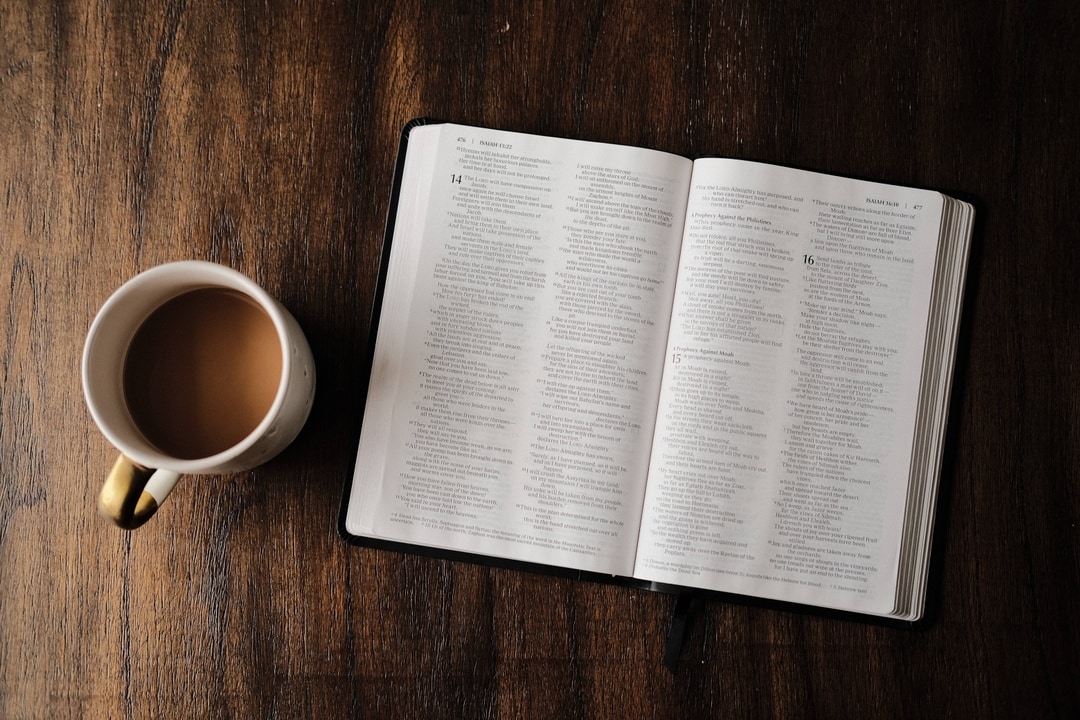 bible next to coffee on a table