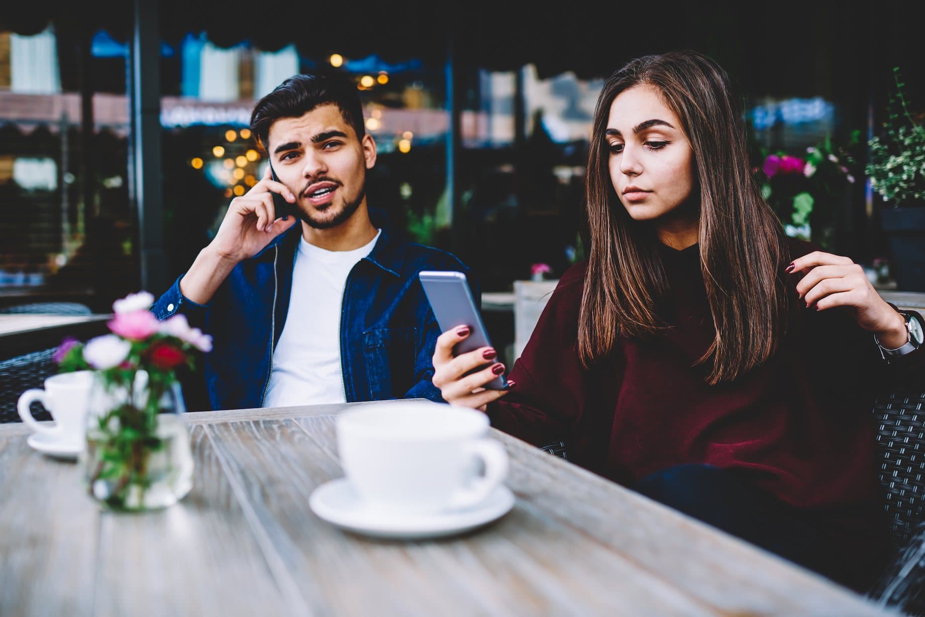 couple at a table on their phone