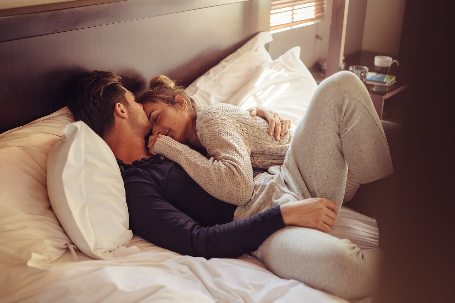 couple hugging on a bed