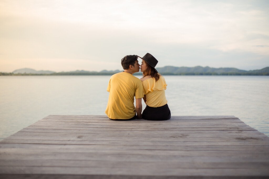 couple kissing on a pier